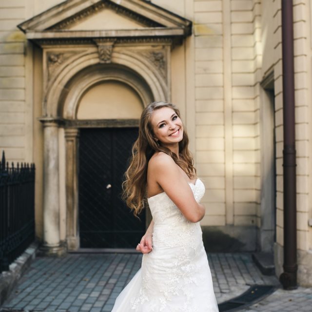 Beautiful bride posing against the backdrop of the ancient churc